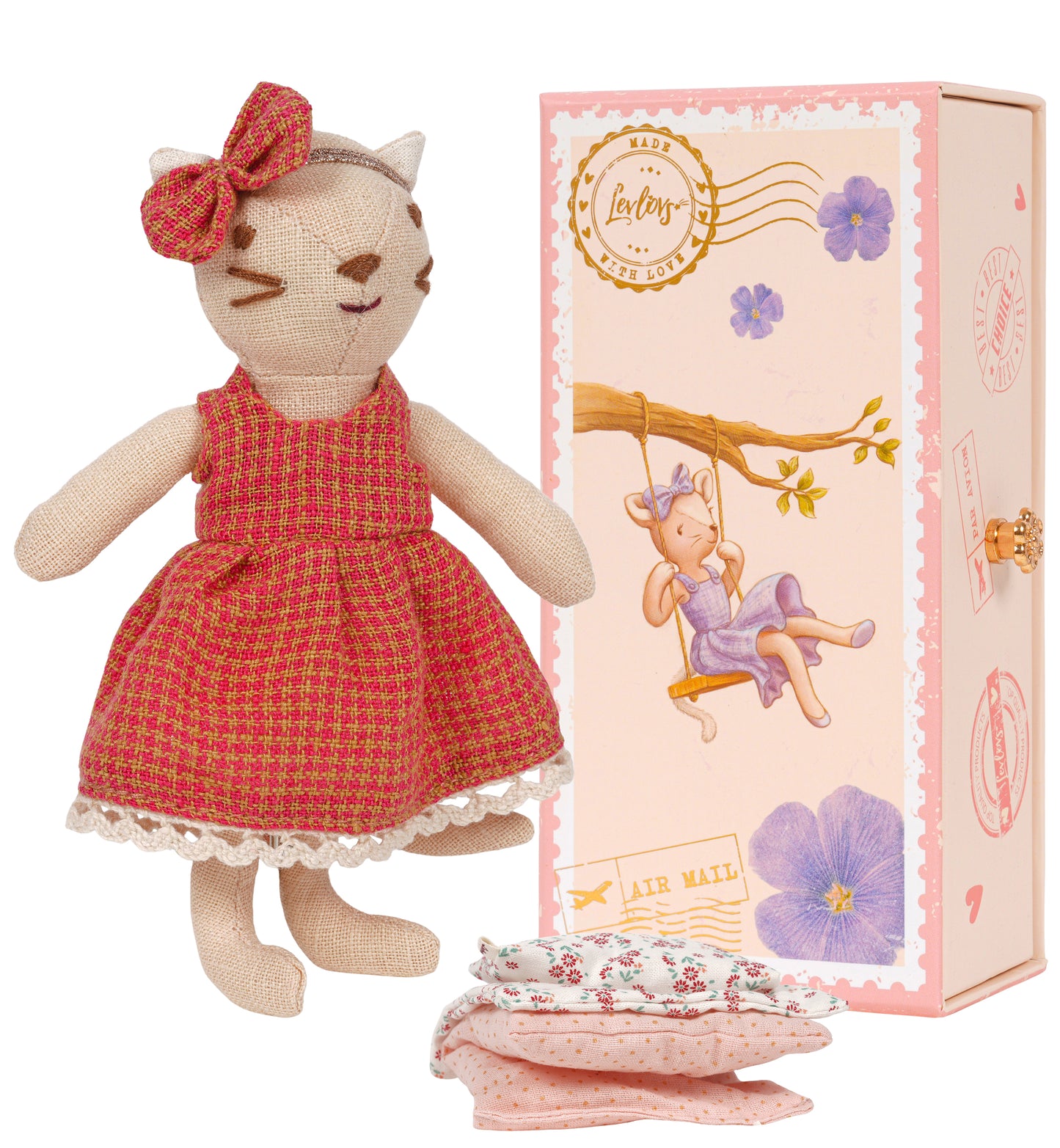 Cat-shaped doll in a red dress with a matching box and fabric pieces on a white background